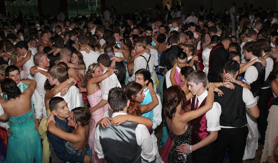 . Many couples enjoy a slow dance at Prom. The couples danced up by the stage close to the stage where the music was the loudest. 