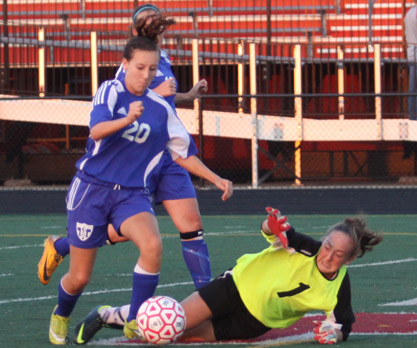 Tarah Hamby (10) dribbles past the Portage goalie and scores her second goal of the game. The varsity team won at Portage on Tuesday.