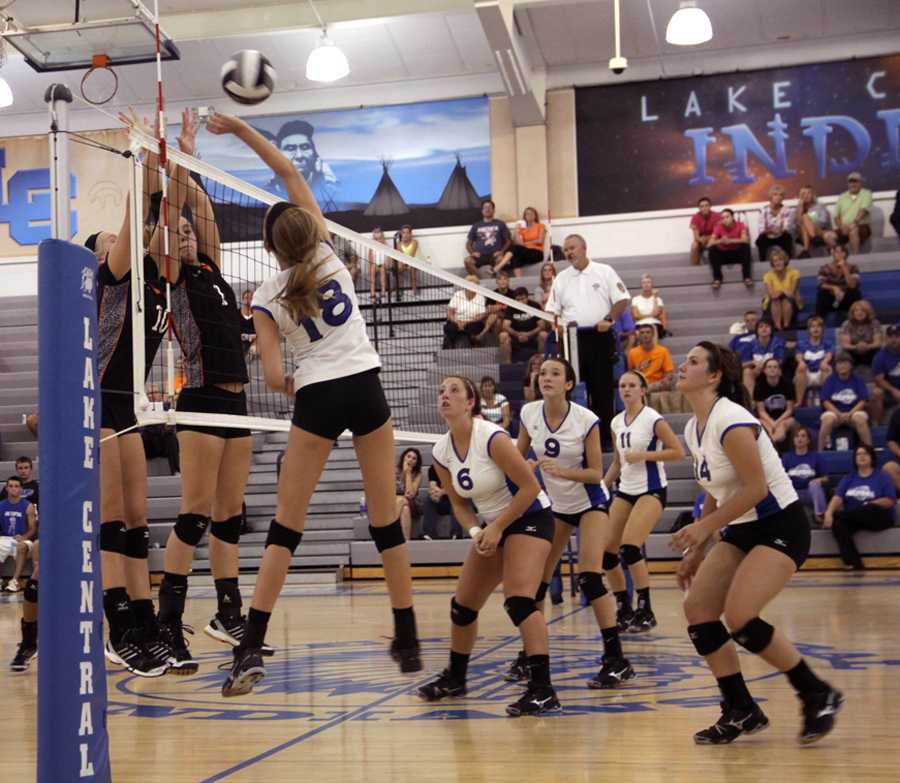 Lauren DiNino (12), Brooke Renner (10), Megan Maletestinic (11), and Julianne Epperson (12), watch intensely as Samantha Anderson (9) spikes the ball between two LaPorte players trying to block. The LC Varsity Volleyball team lost their match Wednesday night against LaPorte in the LC gymnasium.