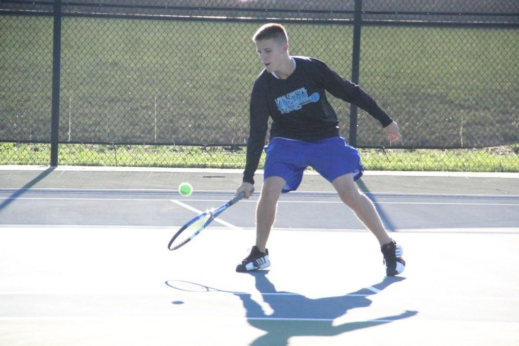 Todd Banvich (12) goes for a backhand shot in Lafayette on Saturday. Banvich lost in the 3 singles championship.