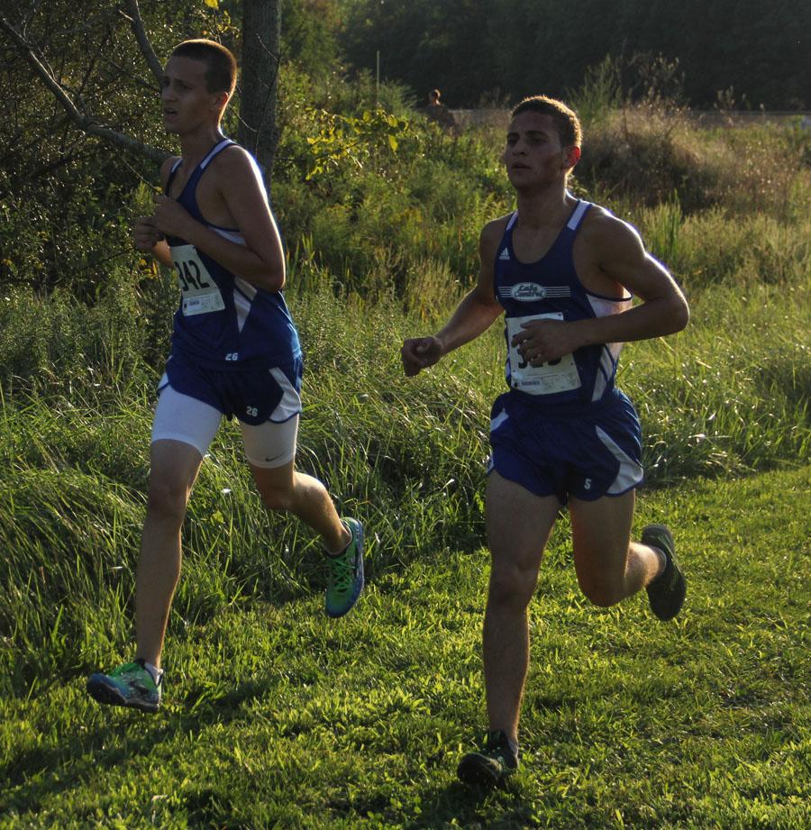 Brian St. John (10) and Darius Arriaga (12) run the last part of their meet on Tuesday. Despite the heat, LC finished with a win against Michigan City and Chesterton. 