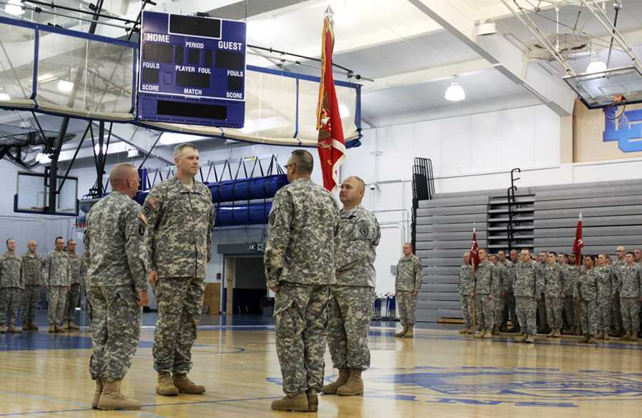 Brigadier General Micheal Osbourne, Major Sean Begley, Lieutenant Stephen Hines and  Command Sergeant Major Jeffrey Duncan prepare to pass the colors to end the Change in Command ceremony. Major Begley assumed the command of 113th Engineer Batallion.