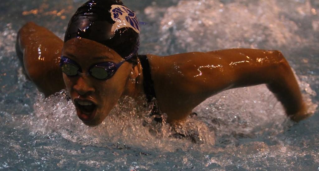 Holly Spears (11) swims the 100 yard butterfly at a swim meet against Merrillville. The team won this meet leaving them undefeated so far for the season.
