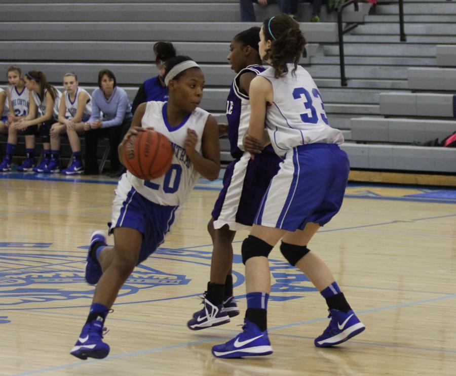  Zhanae Howard (9) and Renee DiNino (9) work together at the basketball game against Merrillville on Thursday.  Howard took the ball down the court while DiNino was on defense. 