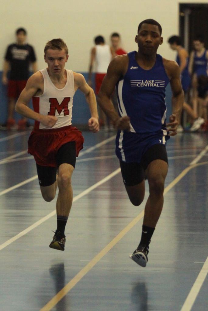 Brady Cooper Jr. (11) sprints down the indoor track at Lake Central.  Cooper kept up with Munster for most of the race, but lost in the end.