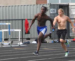 Brandon Scott (10) passes Alex Tucker (12) the baton in the 4 x 1 relay. They continued practicing passing the baton for the DAC meet that was taking place the next day.