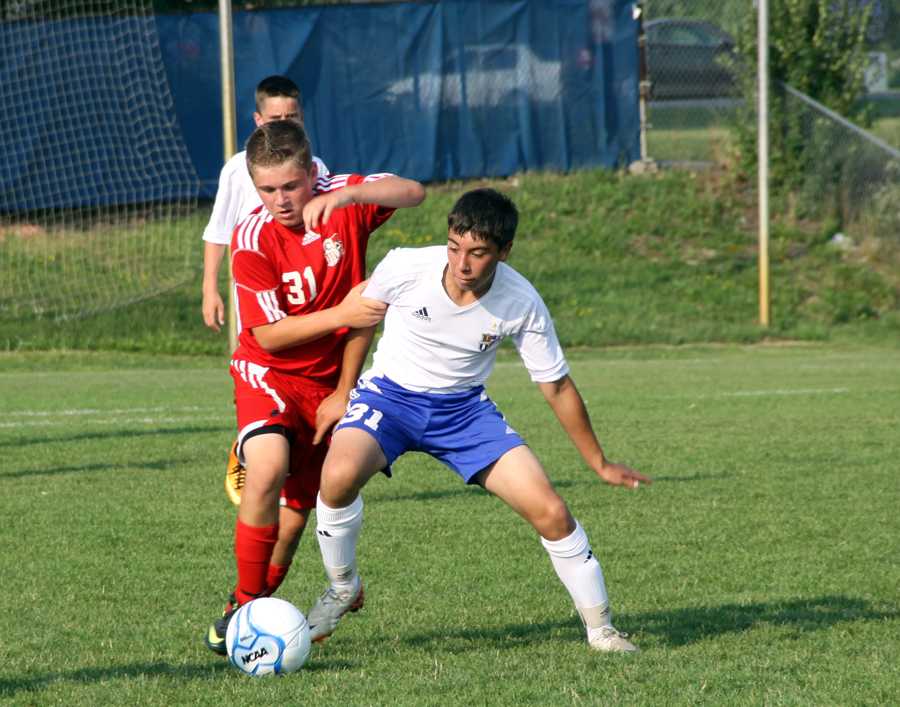 Eric Santiago (10) fights to take possession of the ball.  The JV boys tied 1-1 with Crown Point.