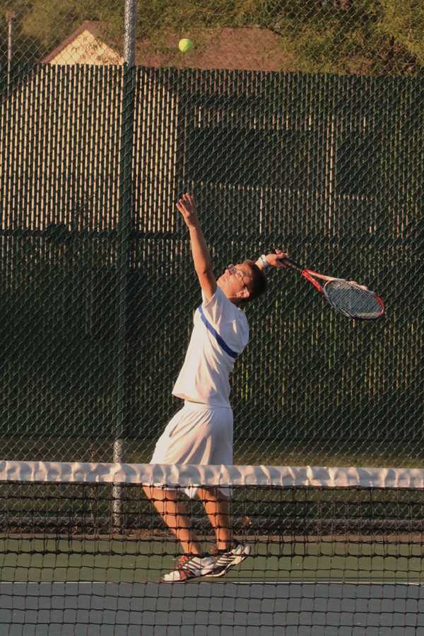 Raymond Pollalis (11) prepares for a serve at the Michigan City home match.  Pollalis played doubles alongside teammate Nicholas Brandner (11).