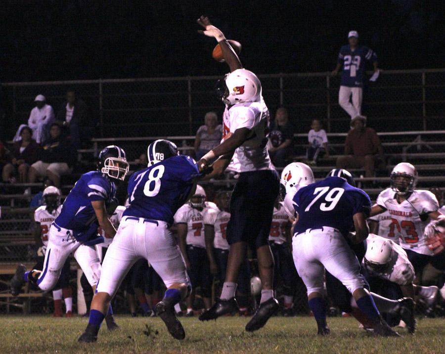 An East Chicago player blocks Colin Studer’s (10) pass while Thomas Quinn attempts to tackle the player.  Studer had five blocked passes throughout the game.