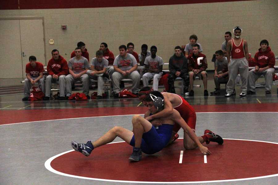 Benamin Geyer (10) wrestles his opponent on his first meet of the season.  Although he did not end up winning his first match, he won the second.