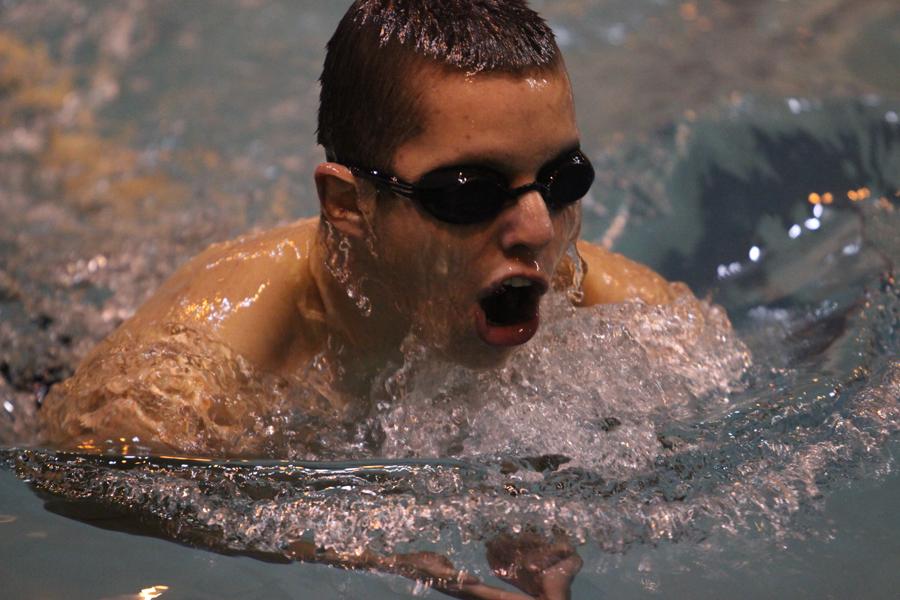Ivano Garzo (10) takes a breath as he swims the butterfly at the swim meet on Dec. 3.  The meet was at home against Valparaiso. 