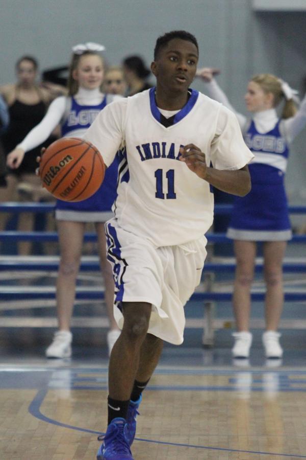 Amir Ransom (11) dribbles the ball down the court.  The team was able to edge out the Cougars and win 34-31.