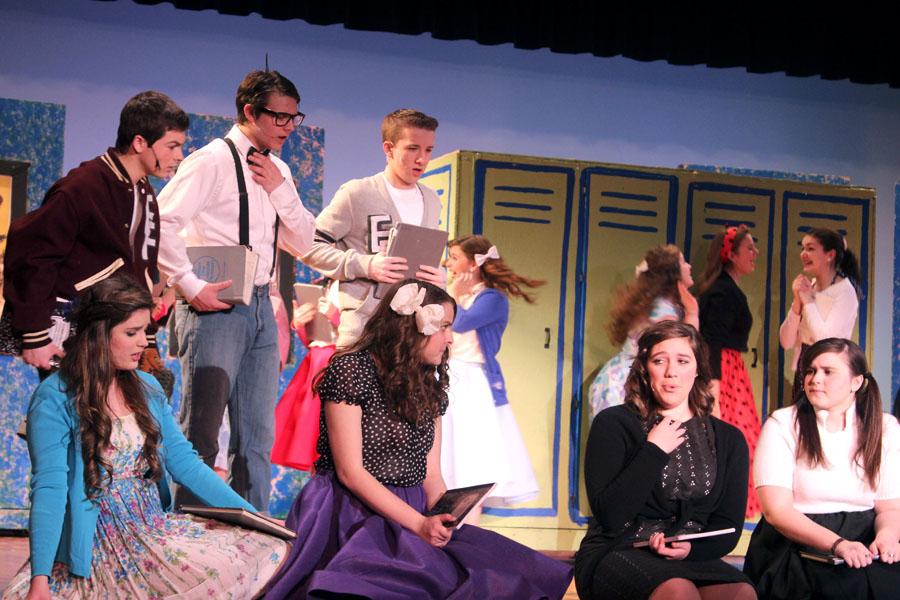  Austin Traina (10), Brett Balicki (10), Adam Gustus (9), Madeline Conley (11), Madison Breford (10), Lauren Bourget (12) and Caroline Janiga (12) practice a scene in the musical, Zombie Prom, during tech week before opening night. Bourget’s character, Toffee, was mourning the loss of her boyfriend as her friends attempted to console her.