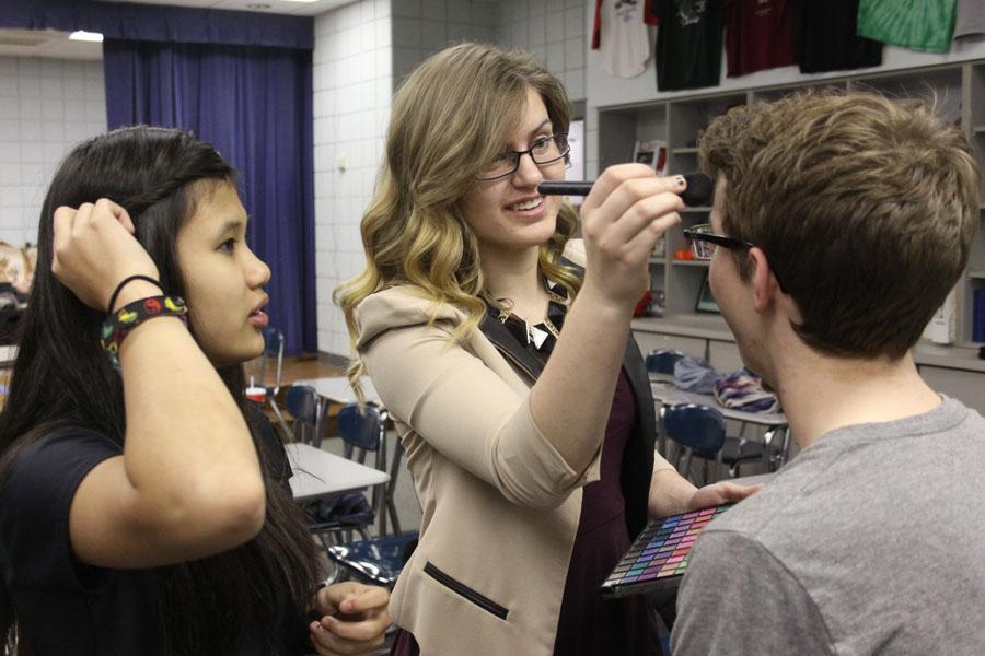 Director Mia Gjeldum (12) does her cast member Adam Gustas’s (9) makeup while fellow cast member Jeannie Lam (9) watches. Both actors were in the show “Cave Dream,” which was about hikers that fall into a cave. 