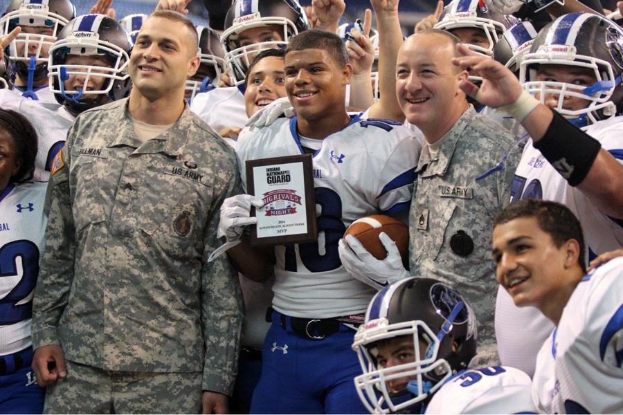 Antwan Davis (12) is awarded Most Valuable Player by the National Guard. Davis snagged two touchdown passes in the Tribes 14-6 victory over Portage.
