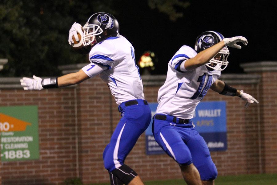 Austin Atkins (10) celebrates with Cody Schultz (12). After Atkins caught his second touchdown pass of the night, Schultz decided to perform a shoulder bump with him. 