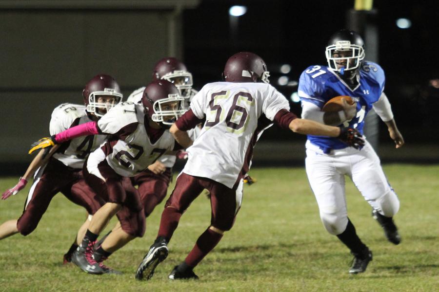 Joshua Williams (9) carries the ball against a number of Chesterton players. The football game was held at Clark Middle School.