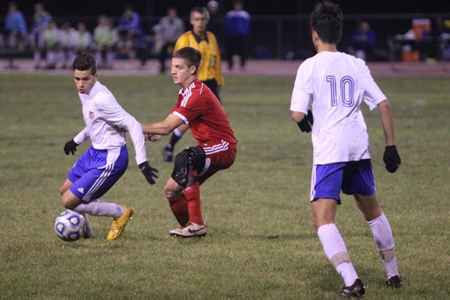 Naser Tahawah (10) attempts to keep the ball away from a Munster player with the help of Michael Flores (12). The game’s final score was 1-0. 