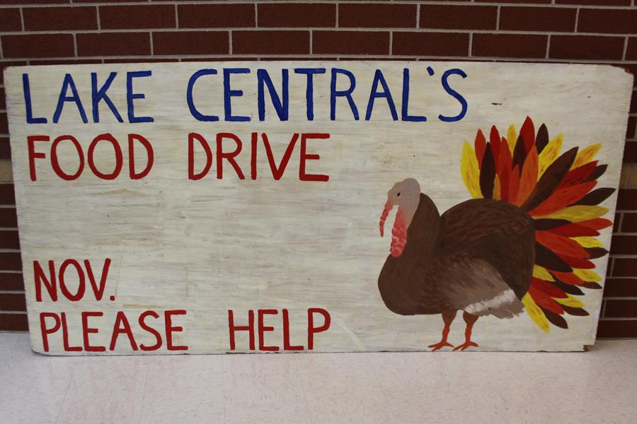 A sign to promote the food drive sits on the balcony of the third floor. The sign was made by the Interact club. 