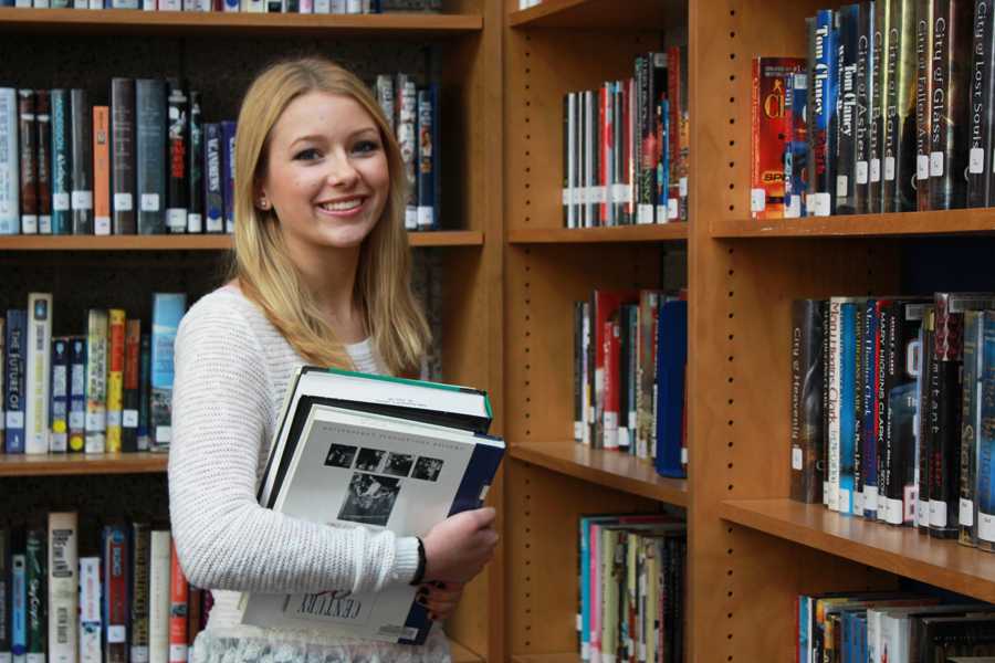Jessica Swatosh (12) poses in the Lake Central library.  For third, fourth and fifth periods, Swatosh traveled to Kolling Elementary School to assist one of the teachers in a program called exploratory teaching.  