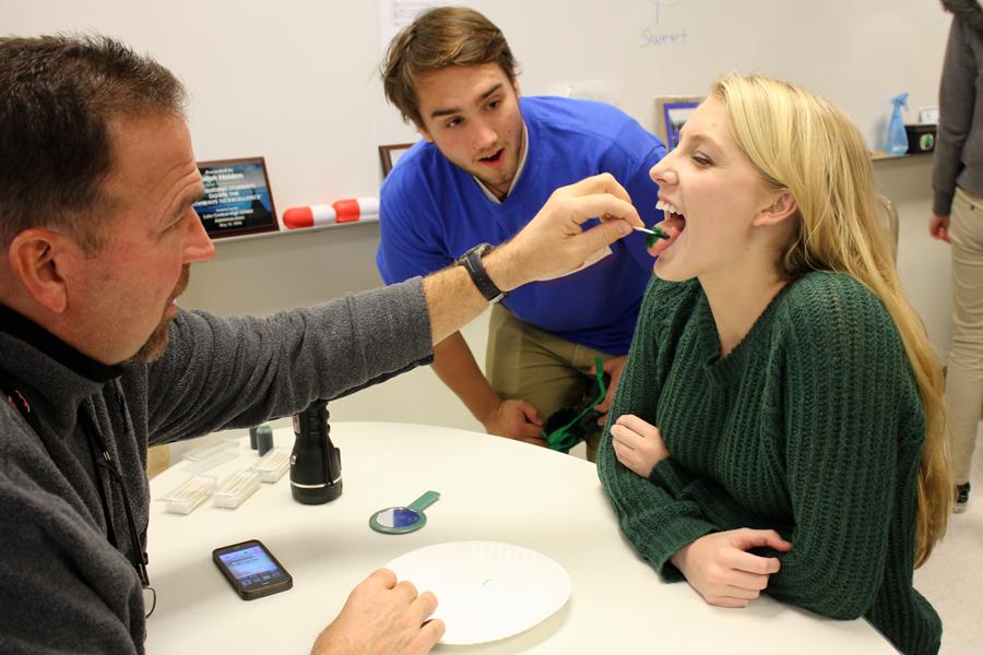 Mr. Ralph Holden, Social Studies and Ryan Ryba (12) look at Lindsey Gercken’s (11) tongue.  Mr. Holden’s AP Psychology class experienced several  activities to conclude their sensation and perception unit.