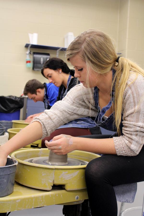 Teigen Breshock (12) raises the walls of her clay.  This process helped form a cylinder-like shape. 