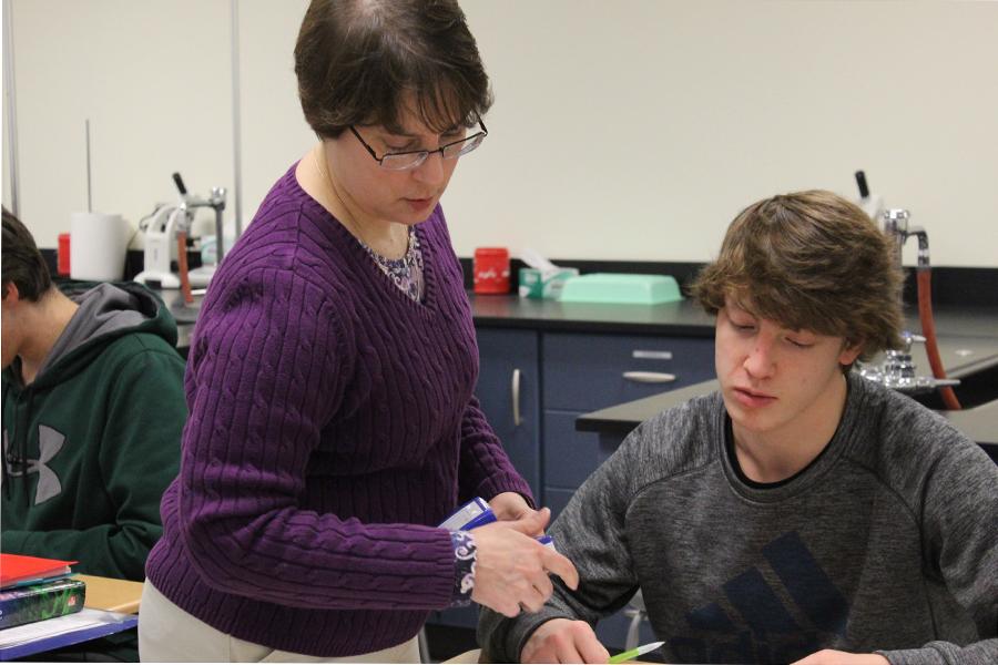 Roberta Harnish, Science, checks her student’s homework during her fourth hour class on Dec. 15. Mrs. Harnish teaches Earth Space Science and Honors Anatomy and Physiology. 
