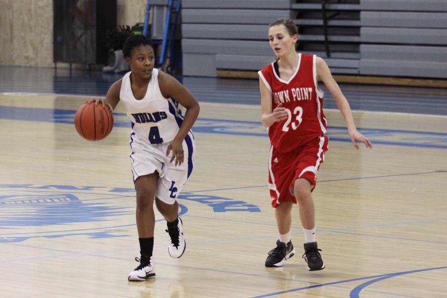 Alaysha Earving (9) dribbles the ball down the court.  Earving was looking for another teammate to help her run the play.  