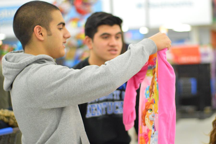 Antonio Gonzalez (10) double checks his gifts before checkout. Angel tree shopping took place on Dec. 11.