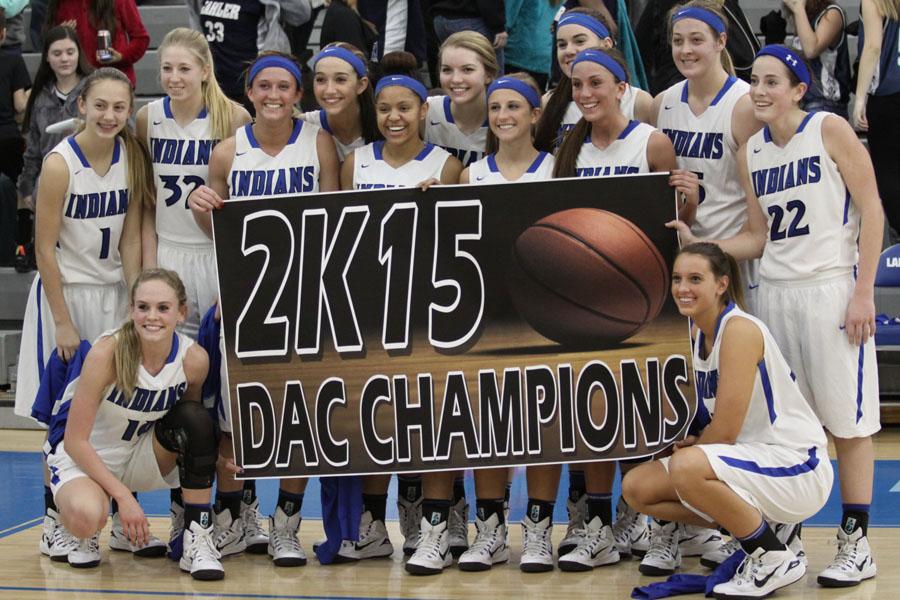 Players from the varsity team celebrate after earning the title of DAC champions in a game against the Valparaiso VIkings. This was the first time in the history of the basketball program that the team was undefeated in the DAC.