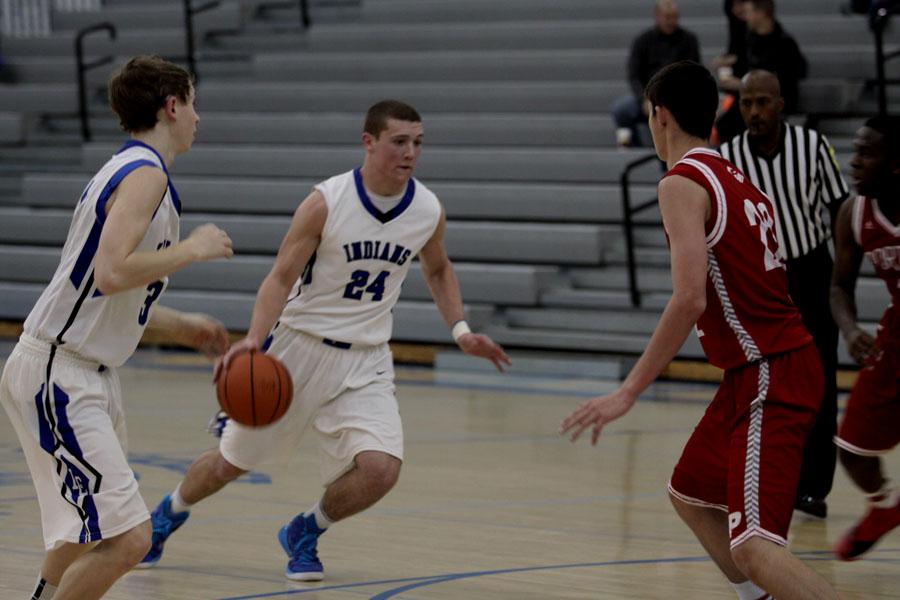 Austin Atkins (10) hunts for an open path to the basket as his defenders retreat.  The game was played at Lake Central. 