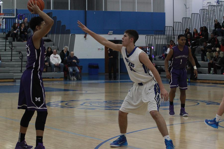 Ian Martin (12) defends a Merrillville player on Lake Central’s court. Martin’s energy was very high.