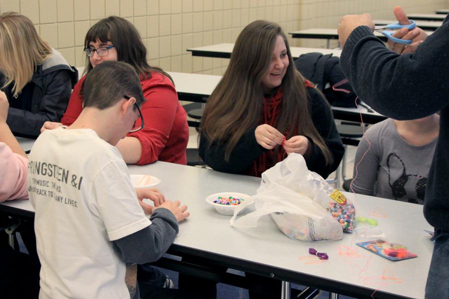 A group of members from Best Buddies participate in making their choice of necklaces and bracelets for either themselves or someone special. The beads used were heart shaped to go with the theme of Valentine’s Day.