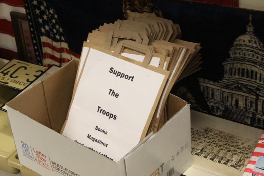 Support the Troops bags sit in a box. These bags were distributed to classrooms throughout the school.