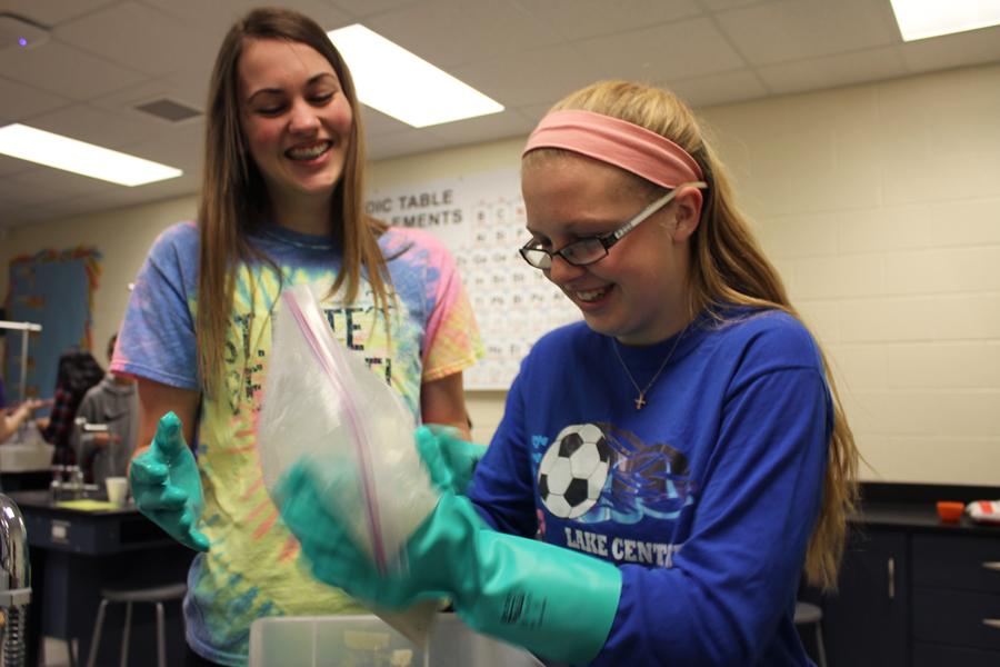 Maja Vidovic (10) and Ashley Scanlon (10) shake a bag filled with salt and ice along with milk, half-and-half and vanilla. The solution created ice cream.