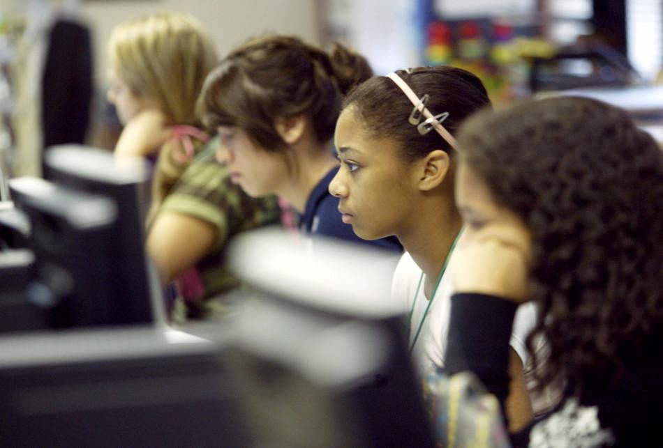Students look at computer screens in school. Cyberbullying affected 14.8 percent of students in the year 2014.
