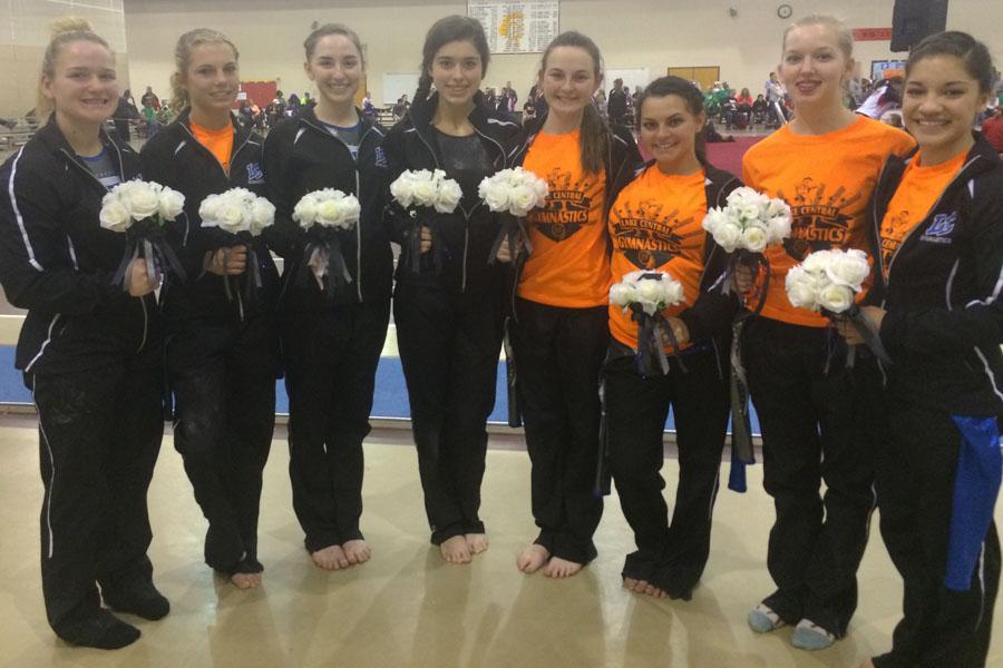 The Girl’s Lake Central Gymnastics team take a picture with their flowers after the Sectionals competition at Chesterton High School on Mar. 7.  Andi Wartman (12) ended up qualifying for Regionals on floor exercise.  
