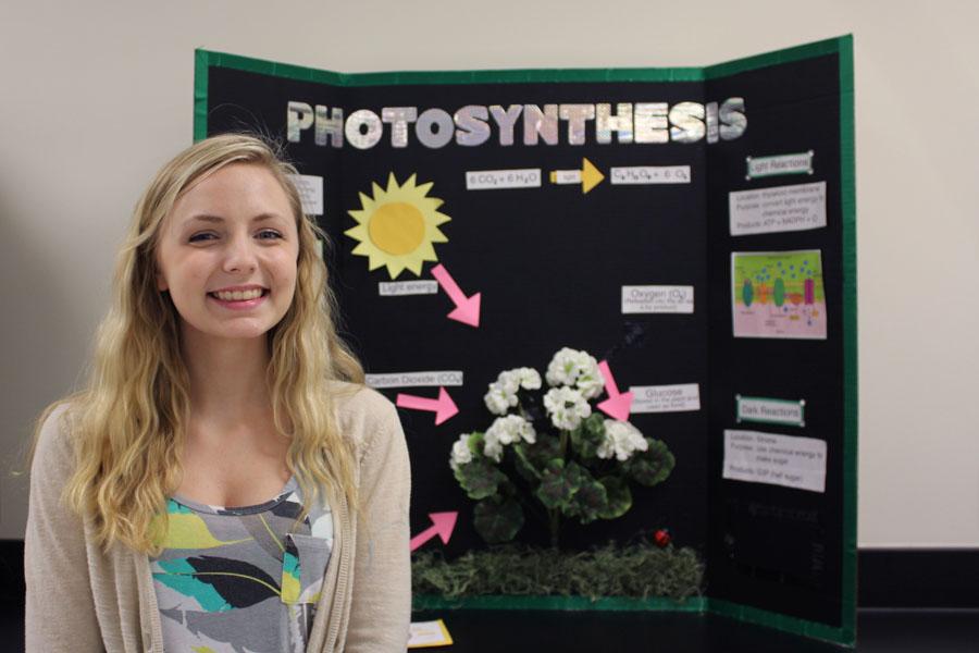 Sarah Hermanek (10) stands in front of a project board in her AP Biology classroom.  Hermanek is interested in many fields of science, including genetic engineering.