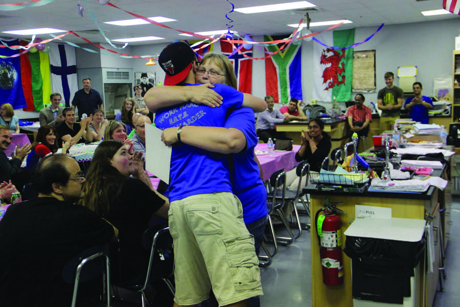 Raymond Pollalis (11) hugs Mrs. Mary Joan Martin, Science, after being presented an award.  Many members won awards as a reward for their work throughout the season.