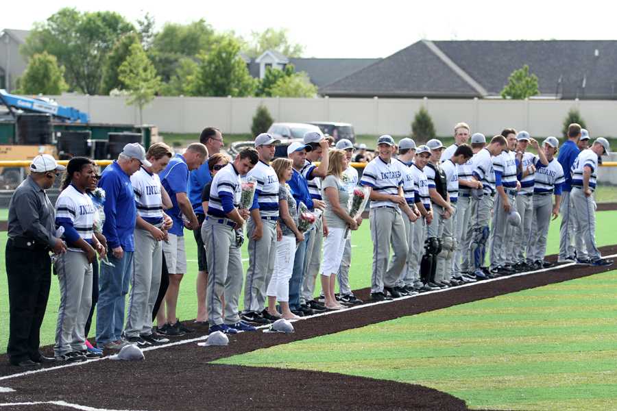 The varsity baseball team stands on the third base line before the game on Friday, May 23 against Hobart. The team beat the Brickies in a 10-1 victory. 