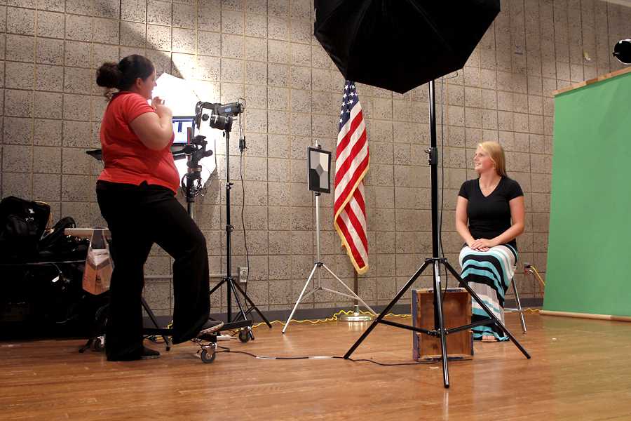 Alyssa Scanlon (12) gets ready for her photo. Students sat in front of a green screen for their school picture. 