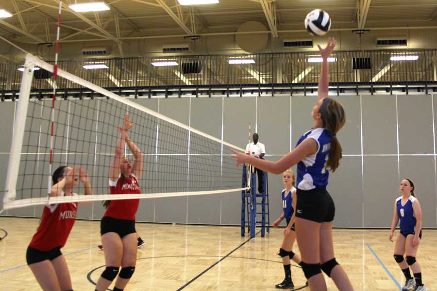 Talia Gruthusen (9) spikes the ball over the net. The game against Michigan City started at 5 p.m.