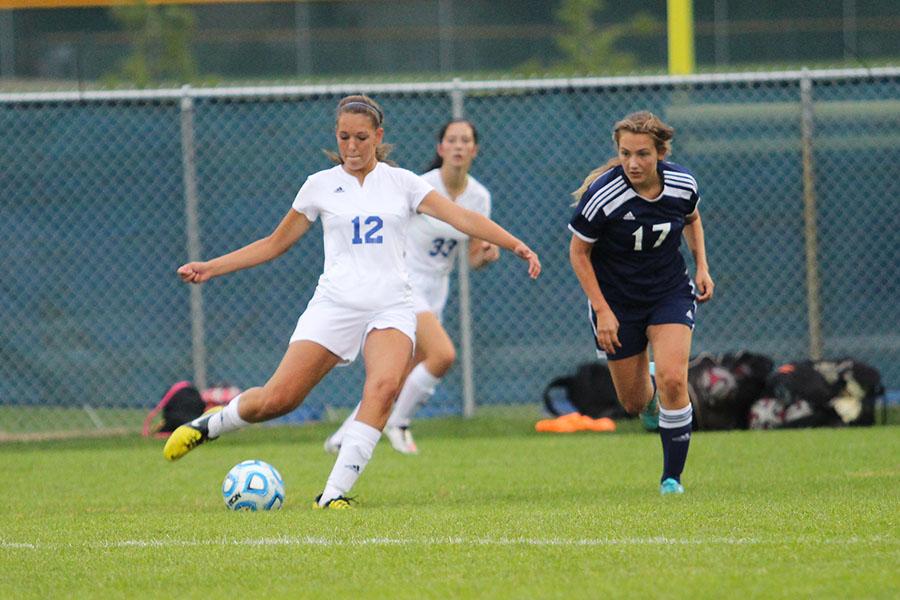 Sydney Dragos (10) goes to kick the ball away from a Michigan City player.  The game began later than expected at 6:45 p.m.