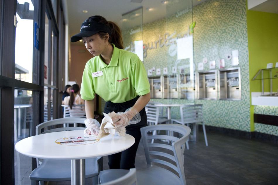 Vivian Pham, 20, wipes down tables during her summer job as an associate at Yogurtland in Huntington Beach, Calif. A second-year student at Golden West College, she didnt work during high school as her mom encouraged her to focus on her studies and sports during school instead of working. (Kevin Sullivan/Orange County Register/MCT)