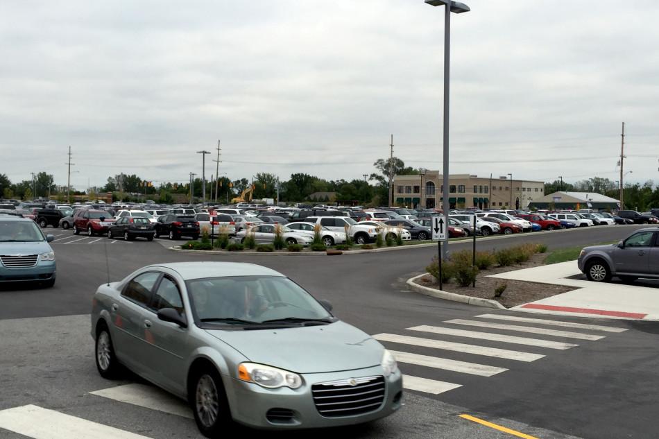 The red parking lot is filled with the cars of students. Senior and junior students had the option of picking between the green, red and blue lot when they registered for a parking pass. 