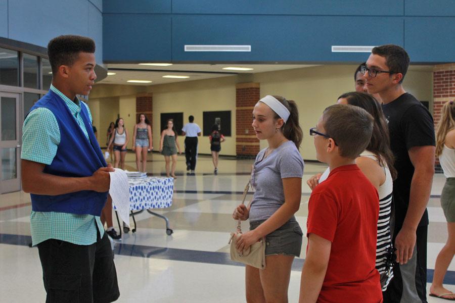 Caleb Beasley (11) leads Grace Richardson (9) and Gunnar Richardson (11) around the new school. Because of all of the construction, tour guides showed students around.