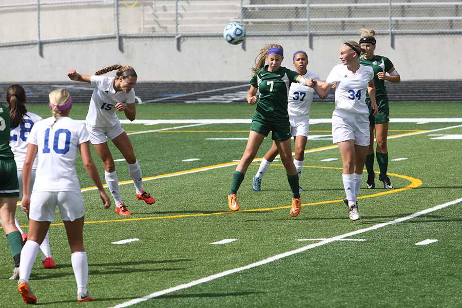Clare Majcrowicz (12), MeghanTeurner (11) and Anika Berg (9) watch Rachel Inglese (12) head the ball up the field. Inglese is a defender on the team.
