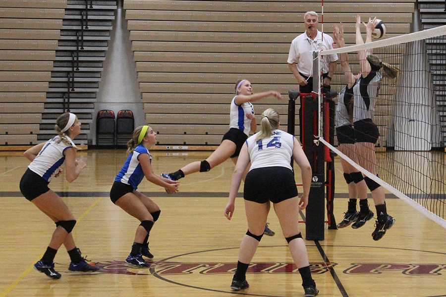 Samantha Anderson (12) spikes the ball to the other side. Tori Gardenhire (12), Mackenzie Evers (12) and Jacquel Eader (12) were ready for when the ball returned to their side of the court.