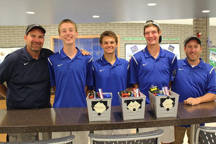 The three senior varsity tennis players pose with their coaches and their senior gifts. Later in the evening, the coaches spoke about each of the seniors and their time on the team.