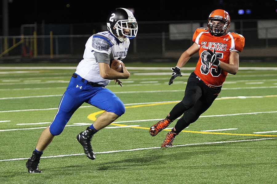 Gavin Cantu (10) sprints down the field with the ball. Cantu threw two touchdown passes over the course of the game.